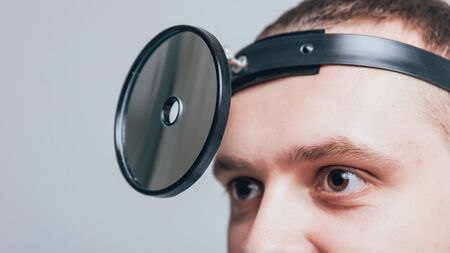 Medical frontal reflector on the doctors headの写真素材