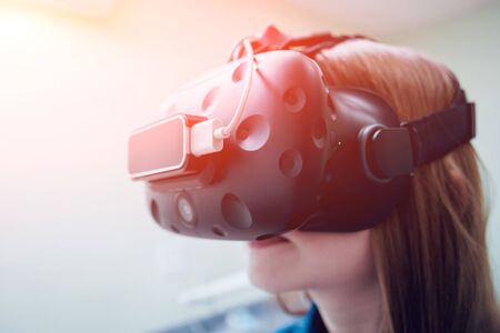 Eye treatment. Patient in virtual reality goggles. Checking the girl's vision with the help of virtual reality. Ortoptics. Pleopticsの写真素材