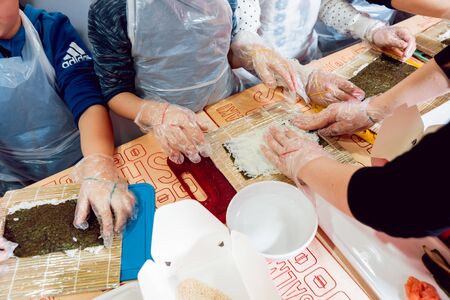 Children prepare sushi and rolls. Master-class restaurant. Backgroundの写真素材