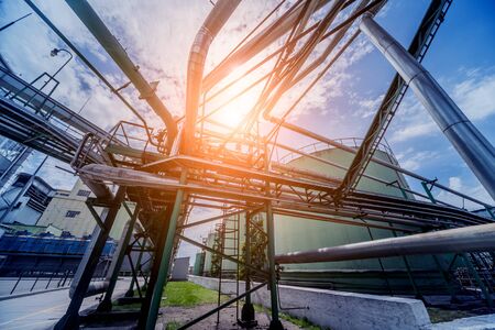 Equipment and pipeline in oil refinery. Industrial background with clear skyの写真素材