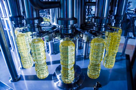 Bottling line of sunflower oil in bottles. Vegetable oil production plant. High technology. Industrial backgroundの写真素材