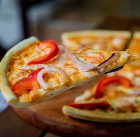 Large pizza on a wooden table. Restaurant.の写真素材
