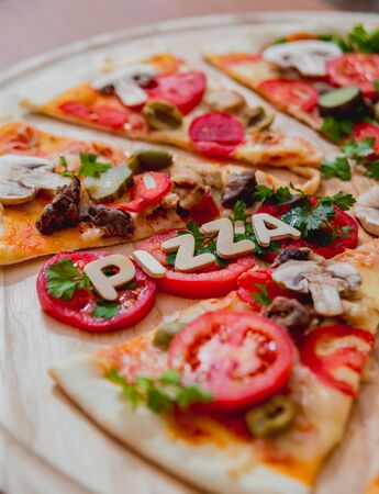Large pizza on a wooden table. Restaurant.の写真素材