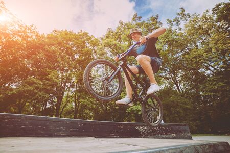 Boy jumping with his bmx in the park. Beautiful backgroundの写真素材