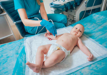 Doctor and little boy patient. Ultrasound equipment.の写真素材