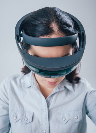 Woman wearing augmented reality goggles. White background