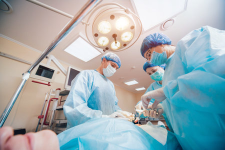 Group of surgeons in operating room with surgery equipment. Background