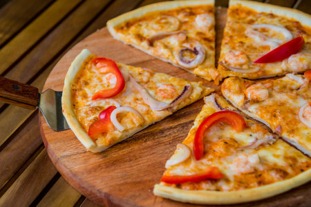 Large pizza on a wooden table. Restaurant