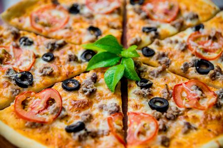 Large pizza on a wooden table. Restaurantの写真素材