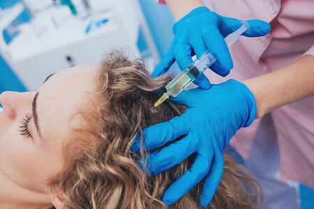 Beautician and the patient in the clinic of aesthetic medicine. The injection.の写真素材