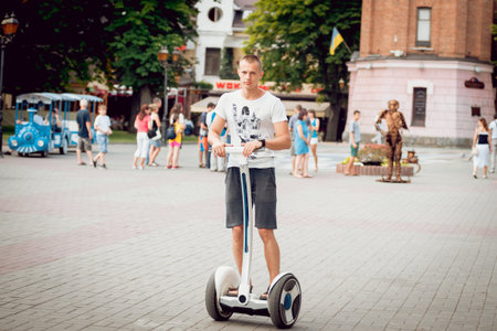 Young man driving on hover board in the park.