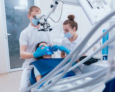 Treatment of root canals under a microscope, work with an assistant.の写真素材