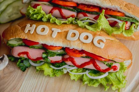 Large hot dog with vegetables on the table. Kitchenの写真素材