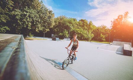Boy riding a bmx in a park.の写真素材