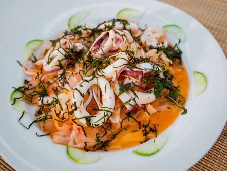 Vegetable salad on a white plate. Restaurantの写真素材