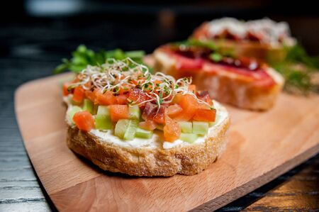 Sandwiches with meat and vegetables on wooden tableの写真素材