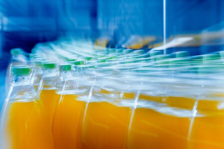 Beverage factory interior. Conveyor with bottles for juice or water. Modern equipmentsの写真素材