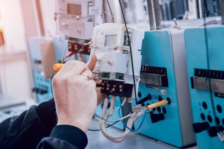 Electrician worker checking electricity meters. Electrical equipment. Backgroundの写真素材