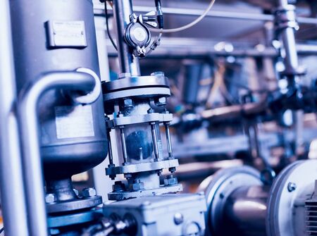 Modern interior of a brewery. Barrels and pipes. Factory interior. Industry backgroundの写真素材
