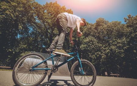 Bmx rider performing tricks at skatepark. Backgroundの写真素材