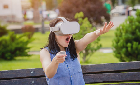 A beautiful young girl plays a game wearing virtual reality glasses