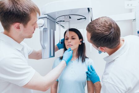 Young woman patient standing in x-ray machine.の写真素材