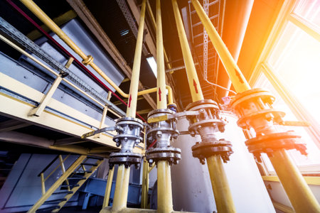 Interior of modern natural oil factory. The piping, pumps and motors. Industry background