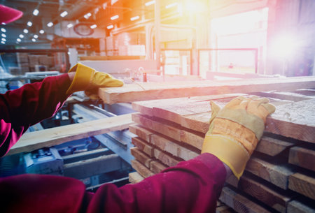 Carpenter with fibreboards at furniture factory workshop. Woodworking industry