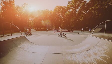 Company of young people on BMX. Beautiful backgroundの写真素材