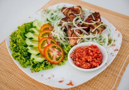 Meat with vegetables on a white plate. Restaurantの写真素材