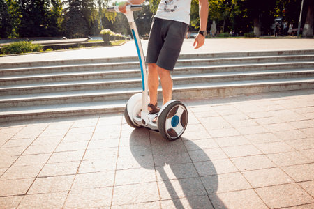 Young man driving on two wheel  in the park.