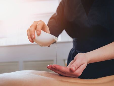 Young girl is relaxing in the spa. Body massage.の写真素材