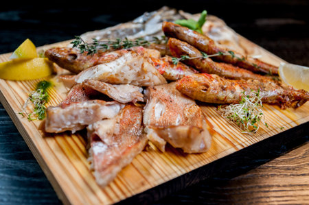 Fried fish on a big wooden board