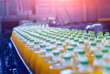 Conveyor with bottles for juice or water. Beverages factory equipmentsの写真素材