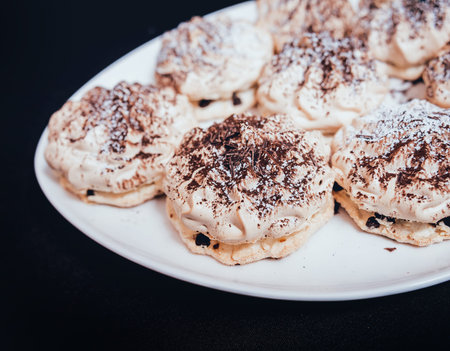 French meringue cookies on the white plate. Restaurant