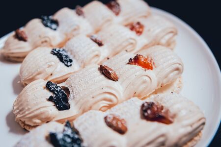 French meringue cookies on the white plate. Restaurantの写真素材