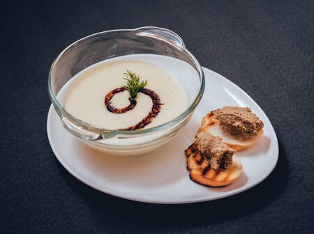 Pumpkin and carrot soup with cream and parsleyの写真素材