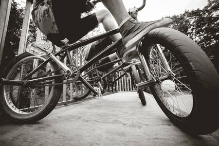 Company of young people on BMX. Beautiful background.の写真素材
