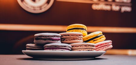 Colorful macaroons. Sweet macarons on retro dark backgroundの写真素材