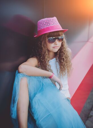 Summer little girl outdoor portrait. Black and redの写真素材