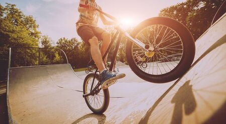 Boy riding a bmx in a park.の写真素材