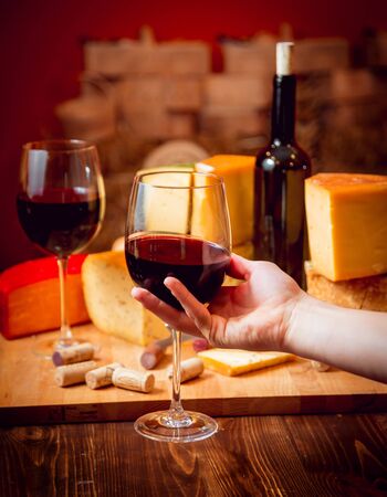 Cheese and wine on a dark table. Beautiful backgroundの写真素材
