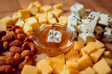 Knife with piece of cheese on a dark table.