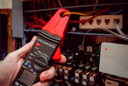 Electrical equipment. Tester in the hands. Background and texture