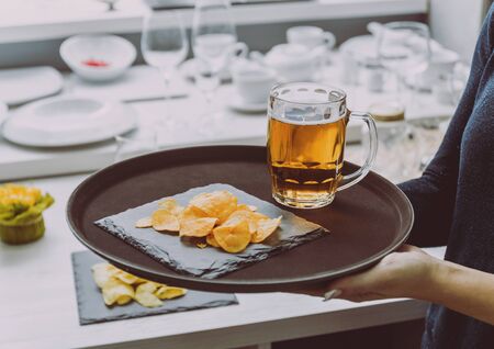 Beer and chips on the large dish.の写真素材