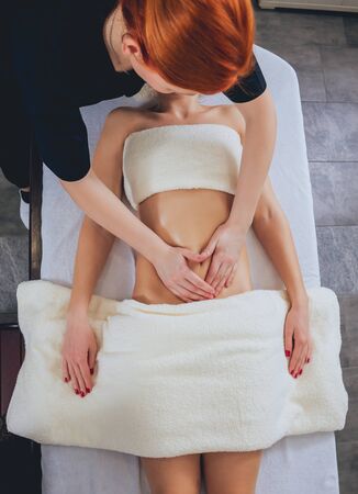 Young girl is relaxing in the spa. Body massage.の写真素材