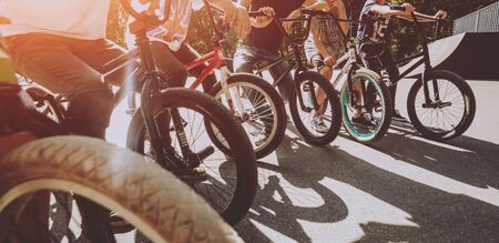 Company of young men on BMX at the skatepark. Outdoorsの写真素材