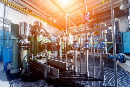 Interior of modern natural oil factory. The piping, pumps and motors