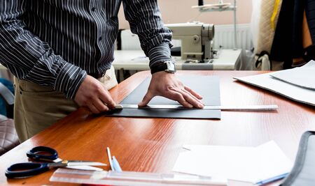 Designer tailor sew seat covers. Man use sewing machine for his work.の写真素材