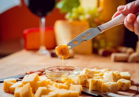 Cheese and wine on a dark table.の写真素材